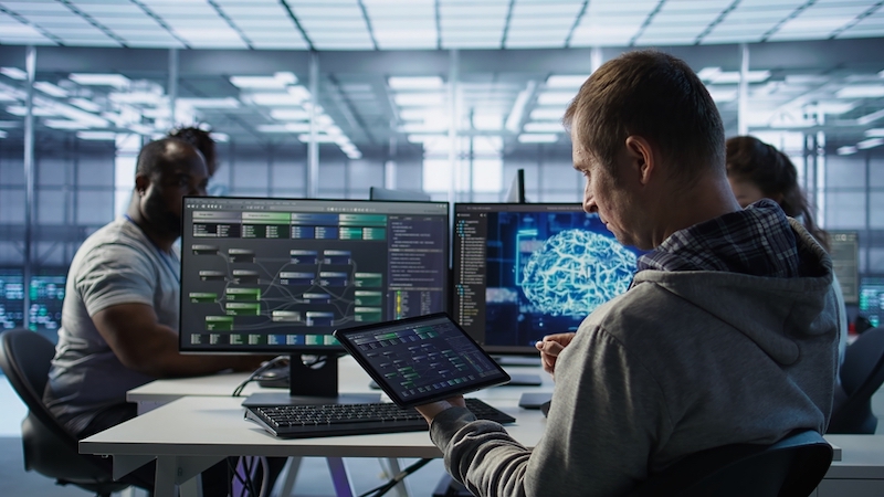 Computer scientist in data center uses AI neural networks. Credit: Shutterstock
